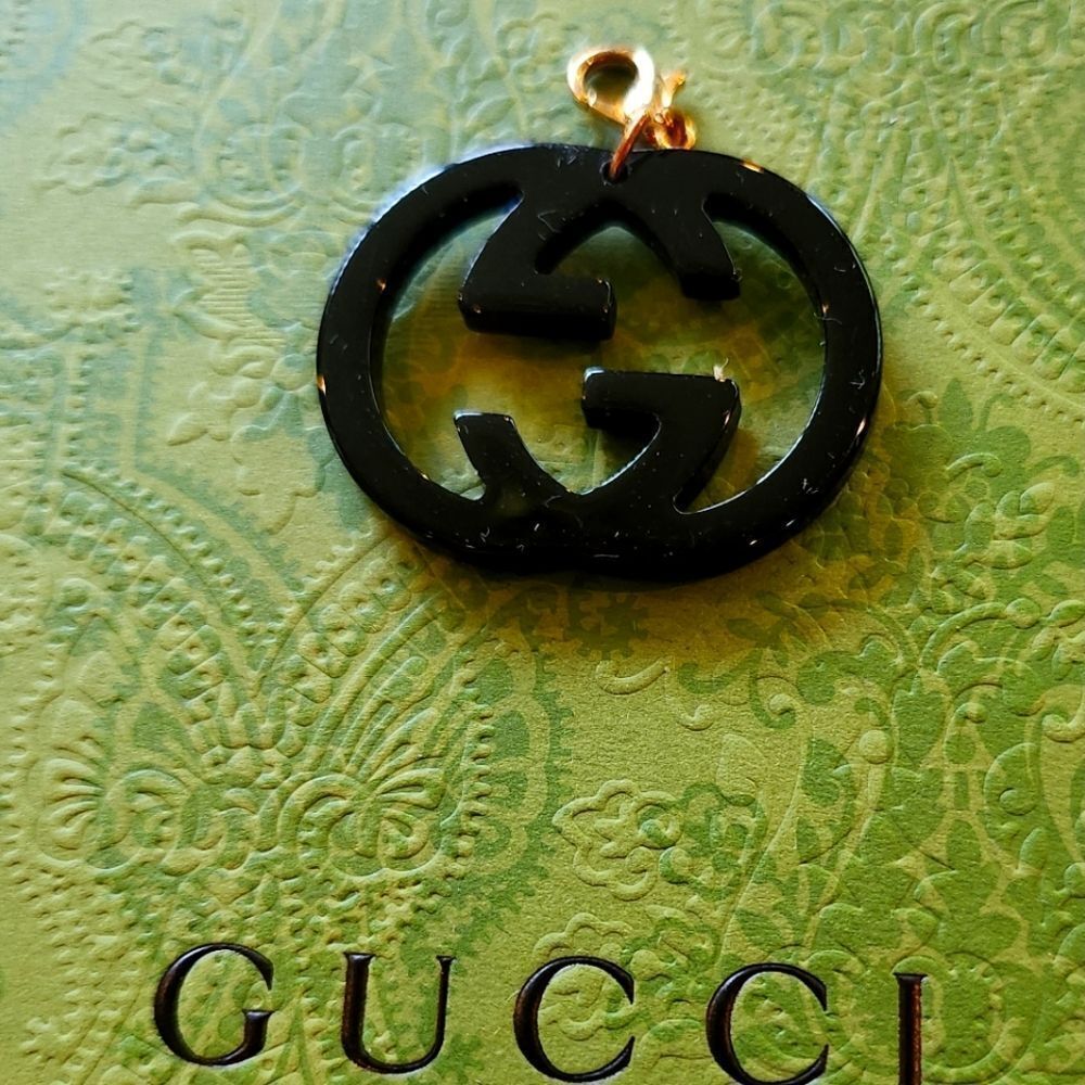 Gucci Black Logo Pendant with Gold Clasp